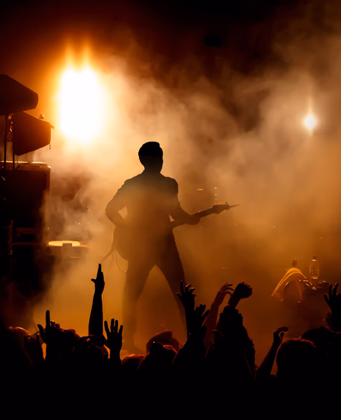 Guitarist silhouette on smoky stage during music release show