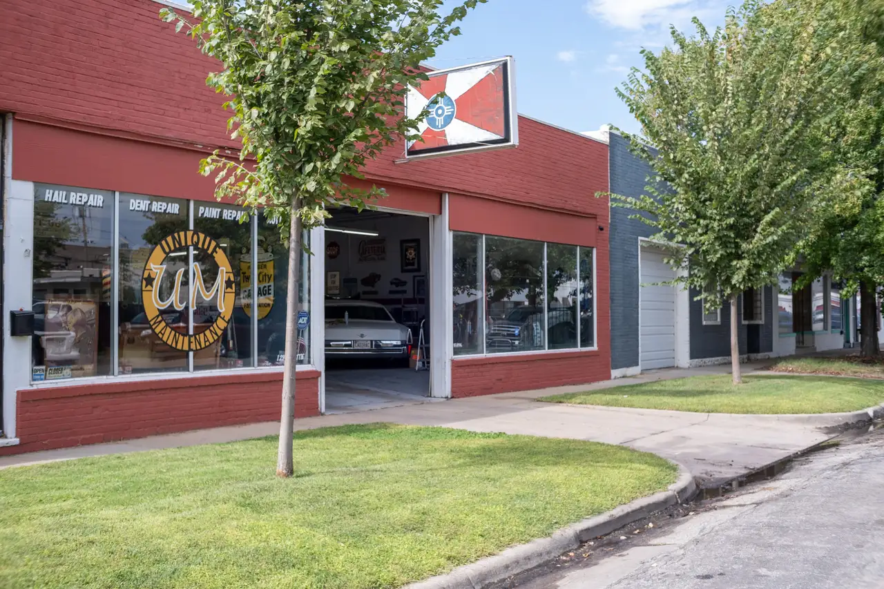 Expert PDR technician using specialized tools for paintless dent repair on vehicle body panel