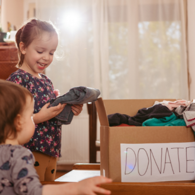 children sorting clothes donation into boxes