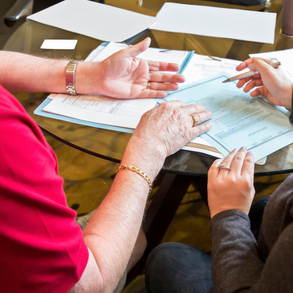 Two people finalising a will in an office