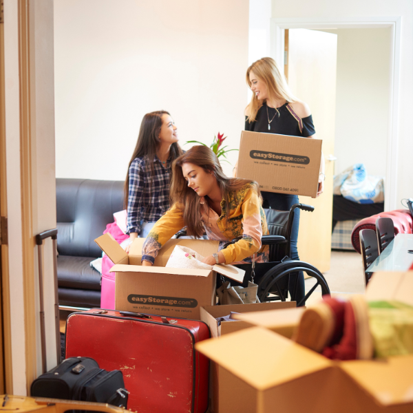 Three female students moving into a shared house