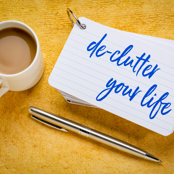 Cup of tea with notecards saying "de-clutter your life"
