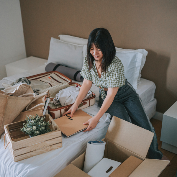Woman packing up suitcases and boxes