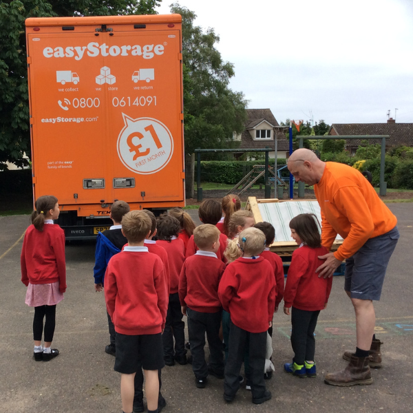 Children behind easyStorage van with van driver