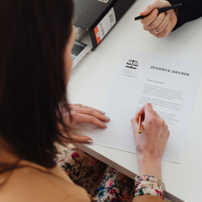 Woman signing her divorce papers