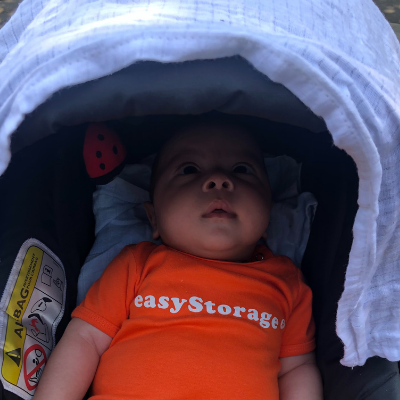 Adorable small child wearing an orange easyStorage onesie