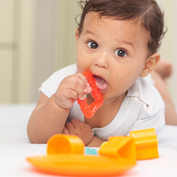 Baby playing with easyStorage orange toys