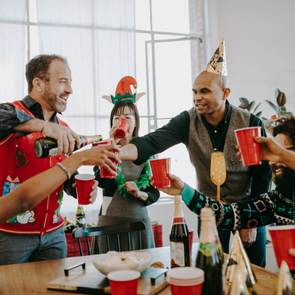 Group of people pouring Champagne at Christmas