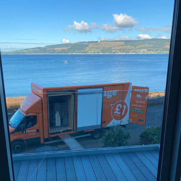 View from a customers window the easyStorage Scotland van by the sea and beach