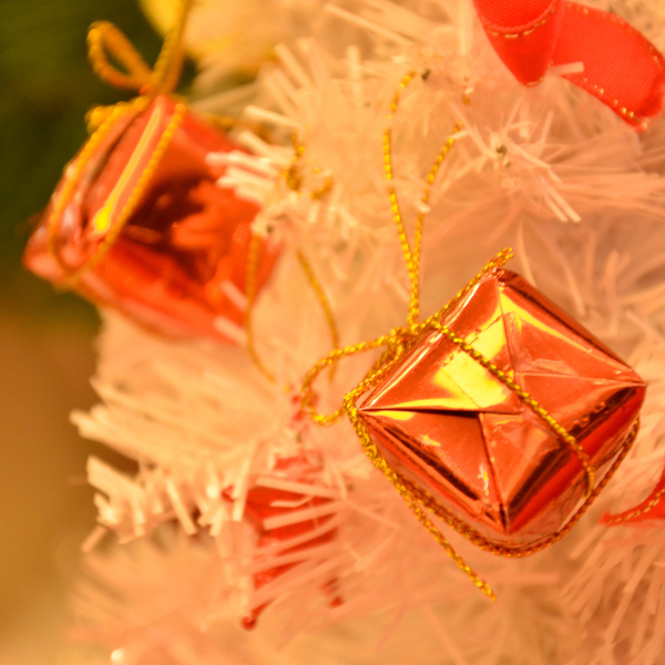 White Christmas tree with orange present decorations