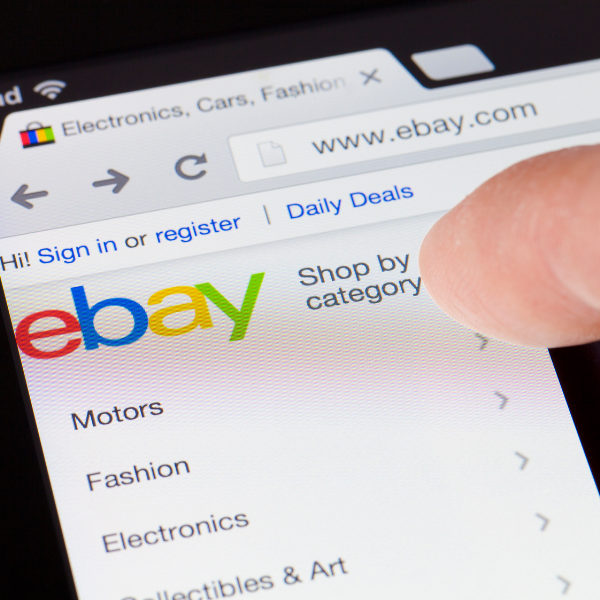ebay home page with someone about to tap shop by category