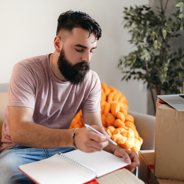 man writing a product description to sell items online