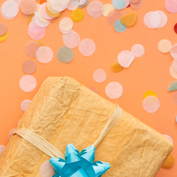 Wrapped wedding present with confetti and a bow