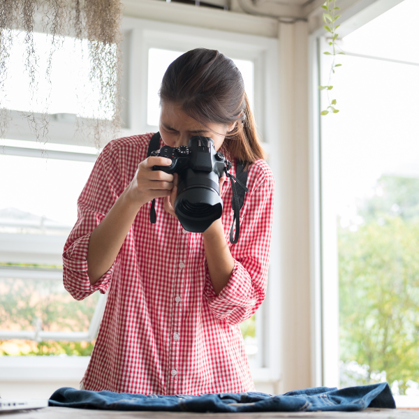 woman using a professional camera of clothes to sell