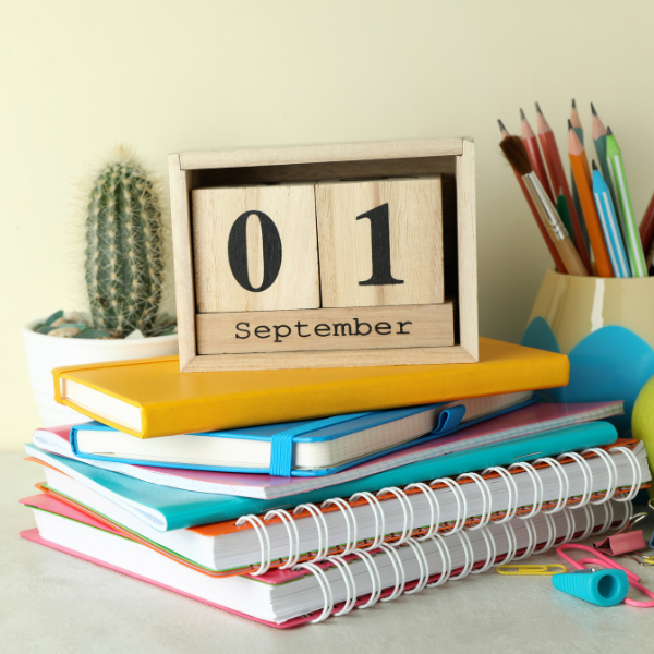 1st September on a pile of notebooks on a desk