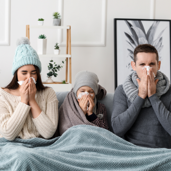 Mother, son and father all blowing their noses, sick with the flu