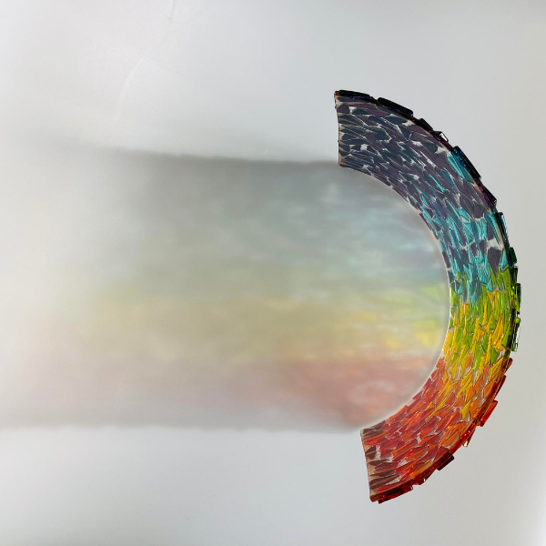 Glass artists' rainbow piece of art with colourful reflection