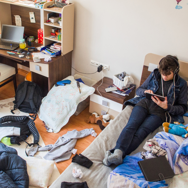 Young man in a messy bedroom