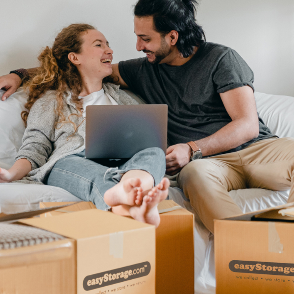 Couple laughing with easyStorage moving boxes around
