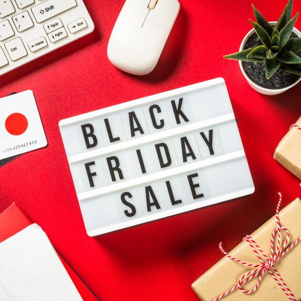 Black Friday Sale sign with computer keyboard and mouse, gifts, bank cards and plant