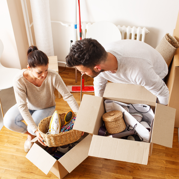 Couple packing boxes to move into a new house