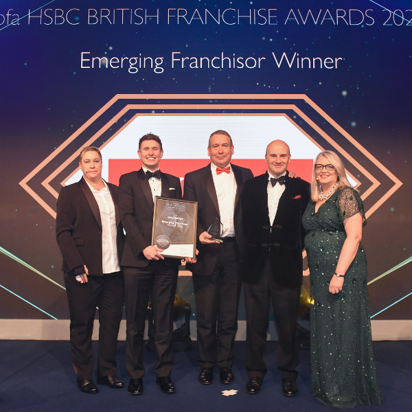The team on stage accepting the emerging franchisor award 2022 