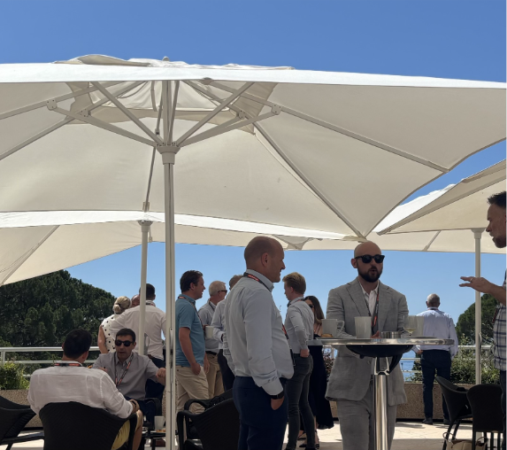 Franchisees talking together on the terrace between conference sessions