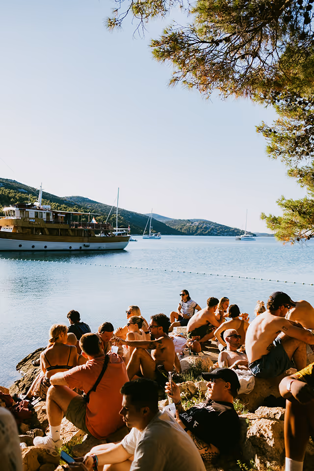 An image of people having fun and relaxing by the coast at Love International Festival.