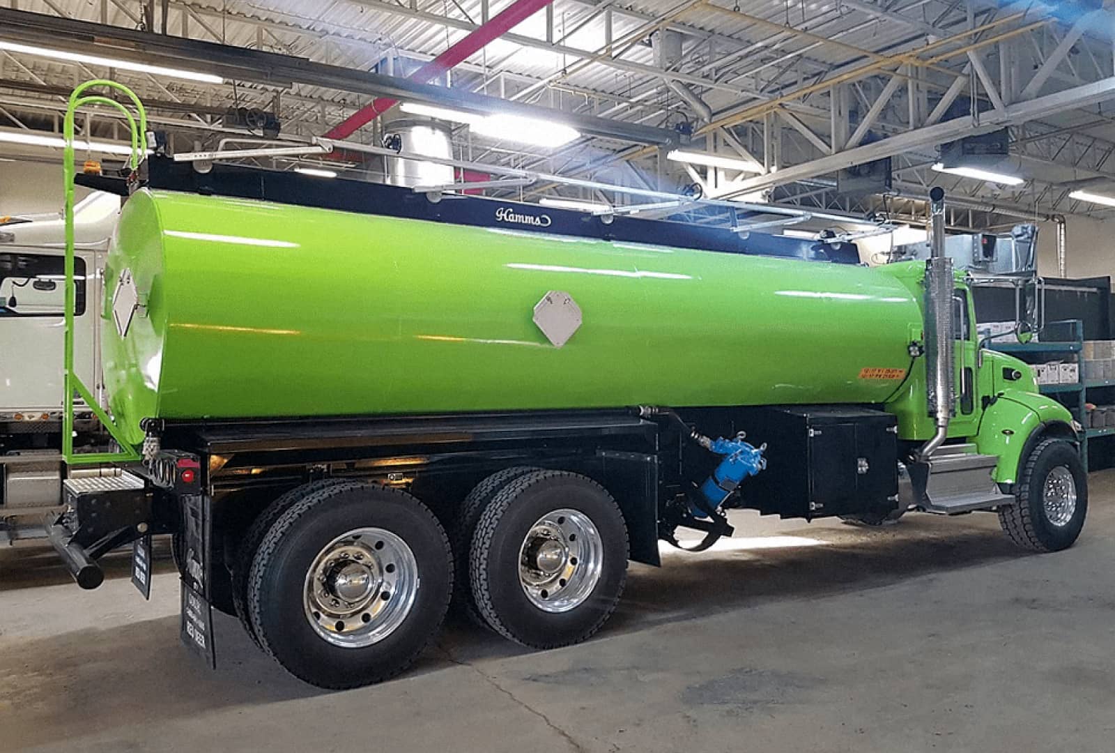Newly painted neon green tank on a truck base
