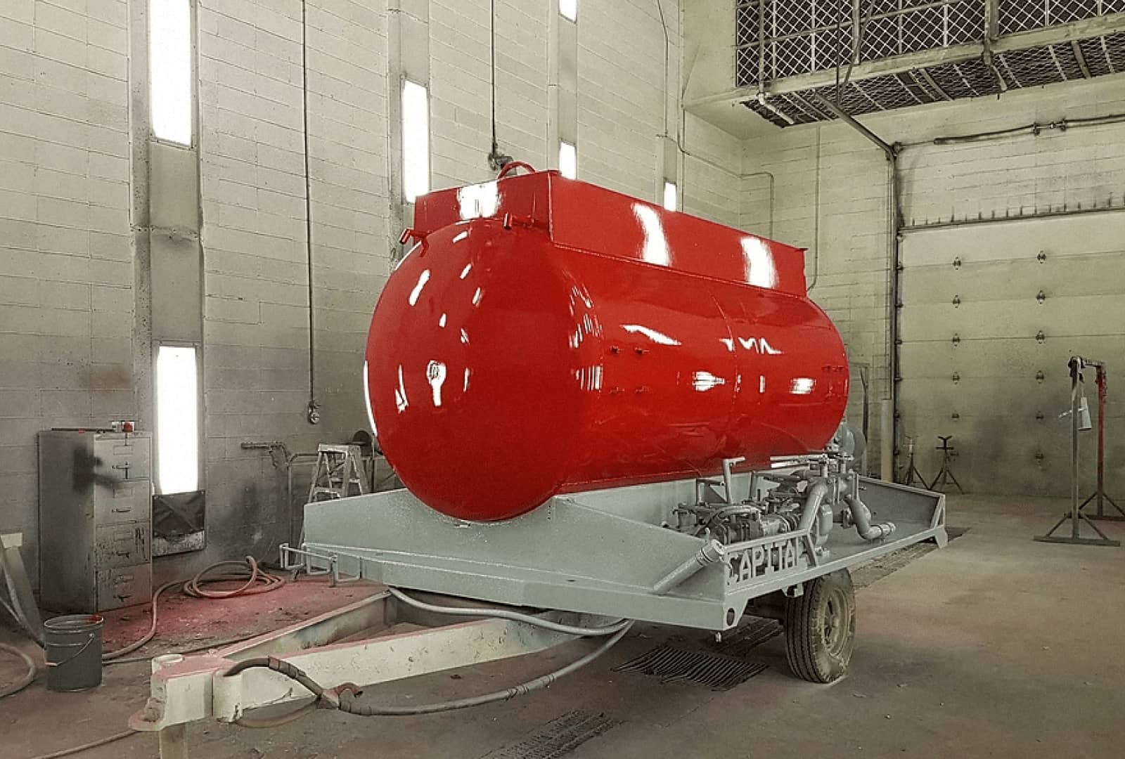 Newly painted cylindrical tank in bright red