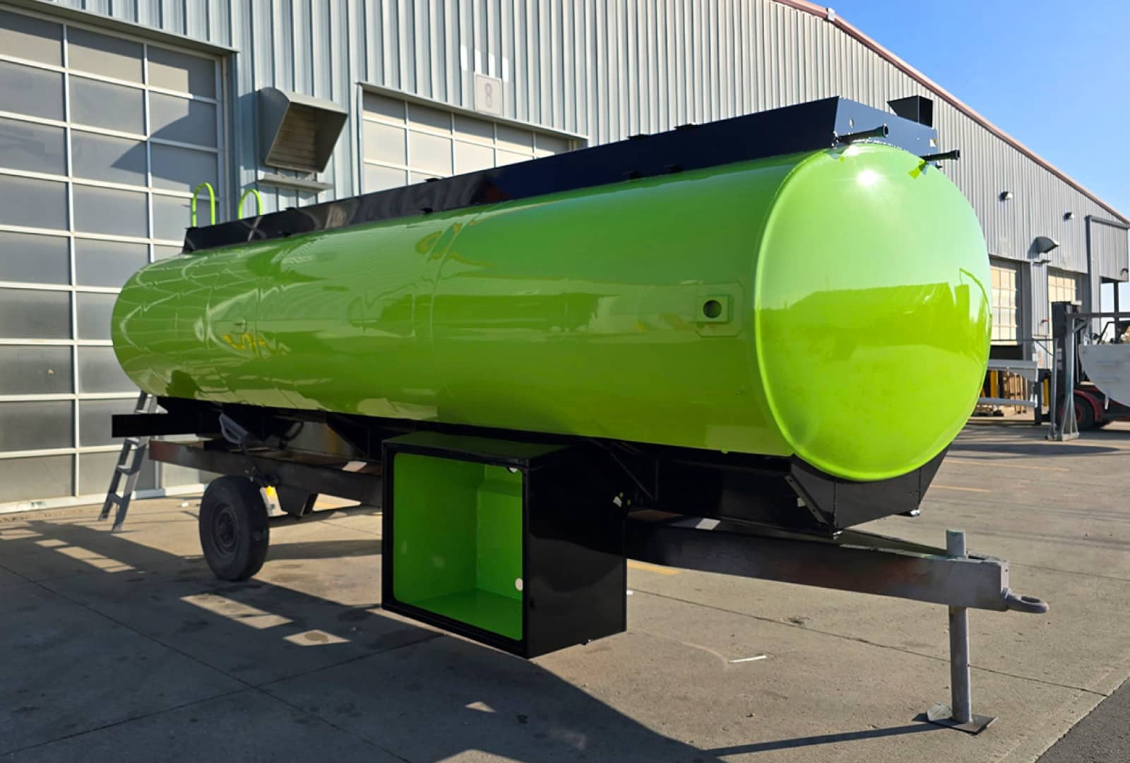 Long cylindrical tank that was recently painted neon green