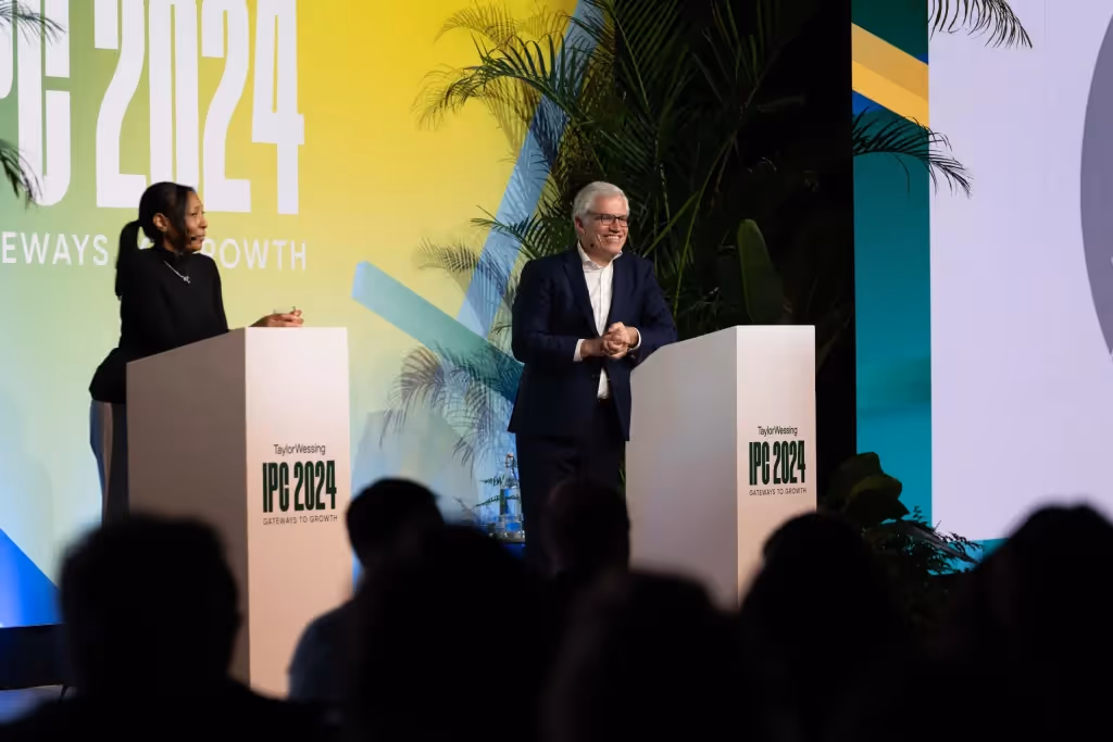 man and woman speaking at conference