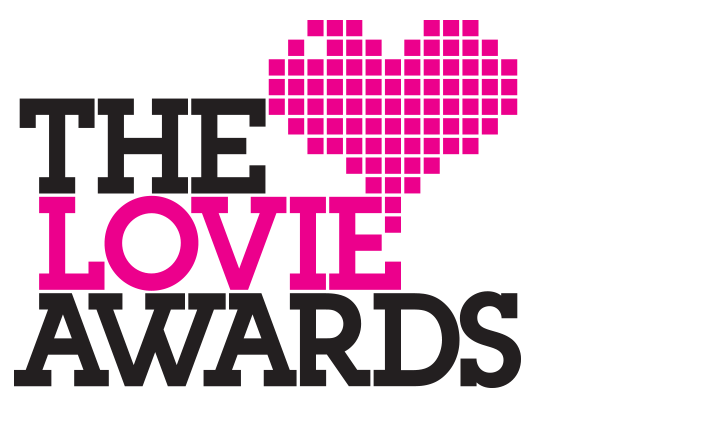 The Lovie Awards logo features the words THE LOVIE AWARDS in bold text, with LOVIE and a pixelated pink heart highlighted in pink, set against a black background.