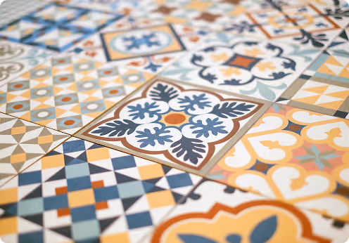 Decorative tiles with intricate geometric and floral patterns in blue, orange, and beige, ideal for home decor and interior design.