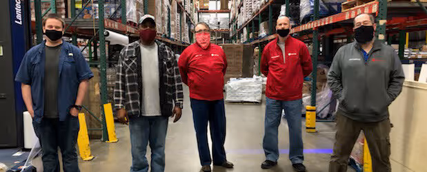 a group of volunteers wear masks in the warehouse