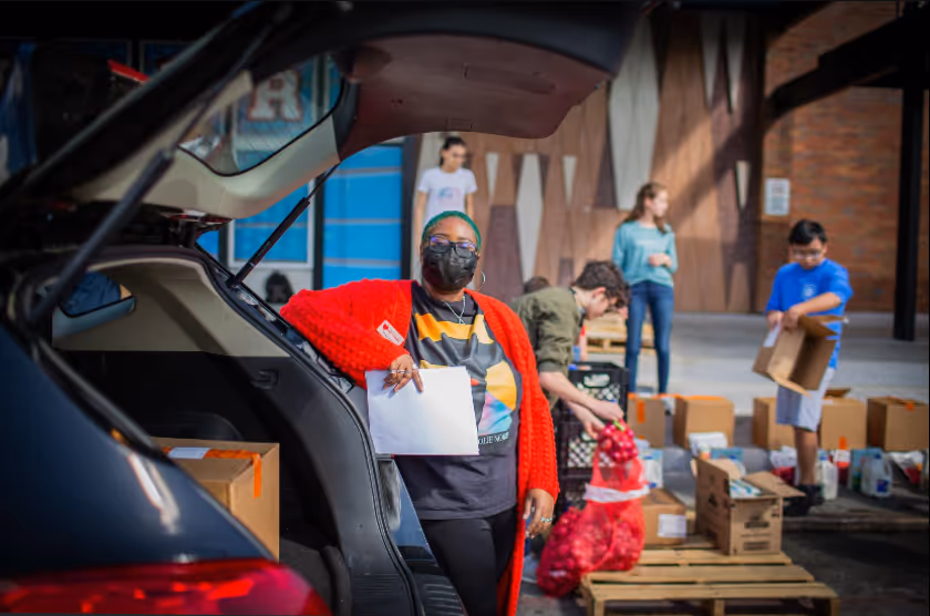 programs coordinator loads food into a van for the mobile pantry