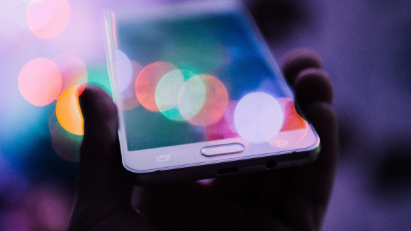 A person holding a Samsung smartphone in their hand