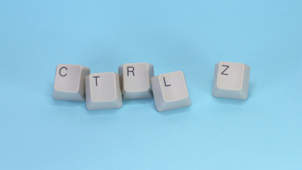 Close-up of a keyboard highlighting the "Ctrl Z" key against a blue backdrop, representing the undo command