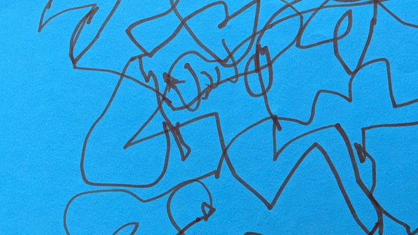 Abstract marker drawing on bright blue paper — dark looping lines cross and tangle densely across the full surface, forming an energetic, layered web of interconnected shapes.