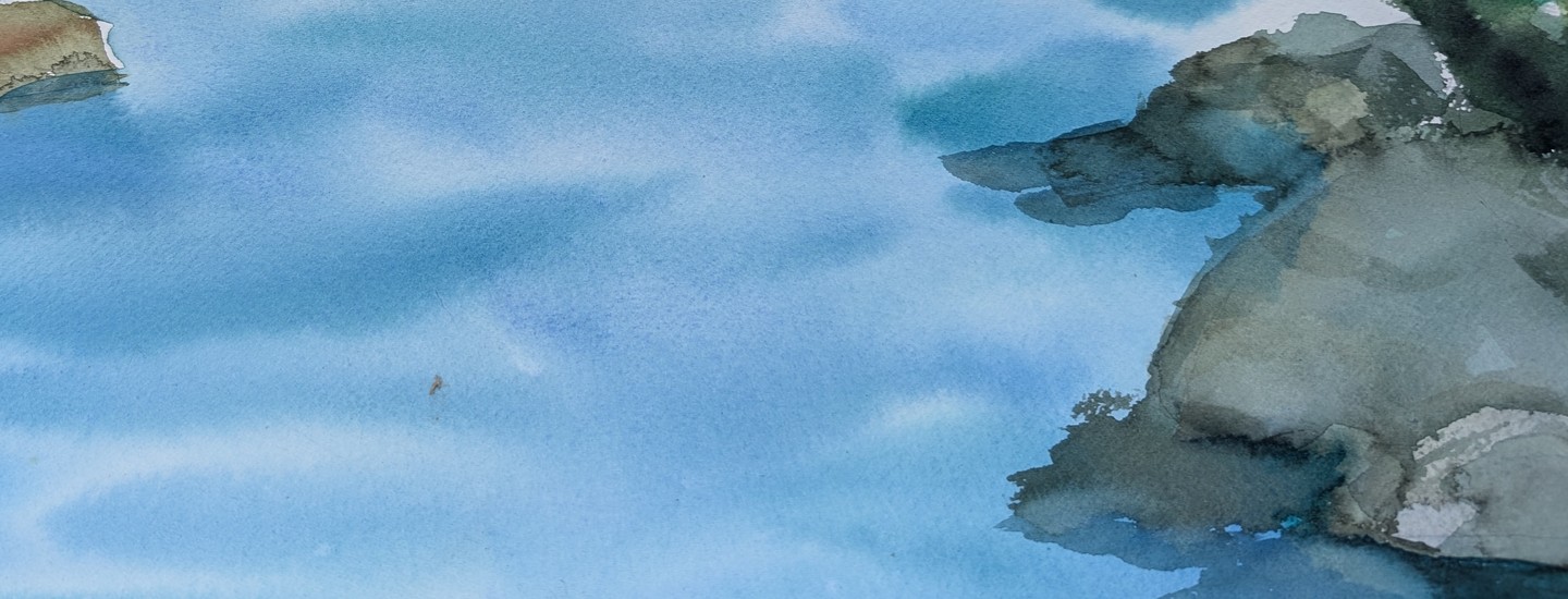 Watercolor of grey-green rocks layered in translucent washes along the right edge, meeting soft, overlapping bands of blue water. Quiet, light, and loosely abstract.
