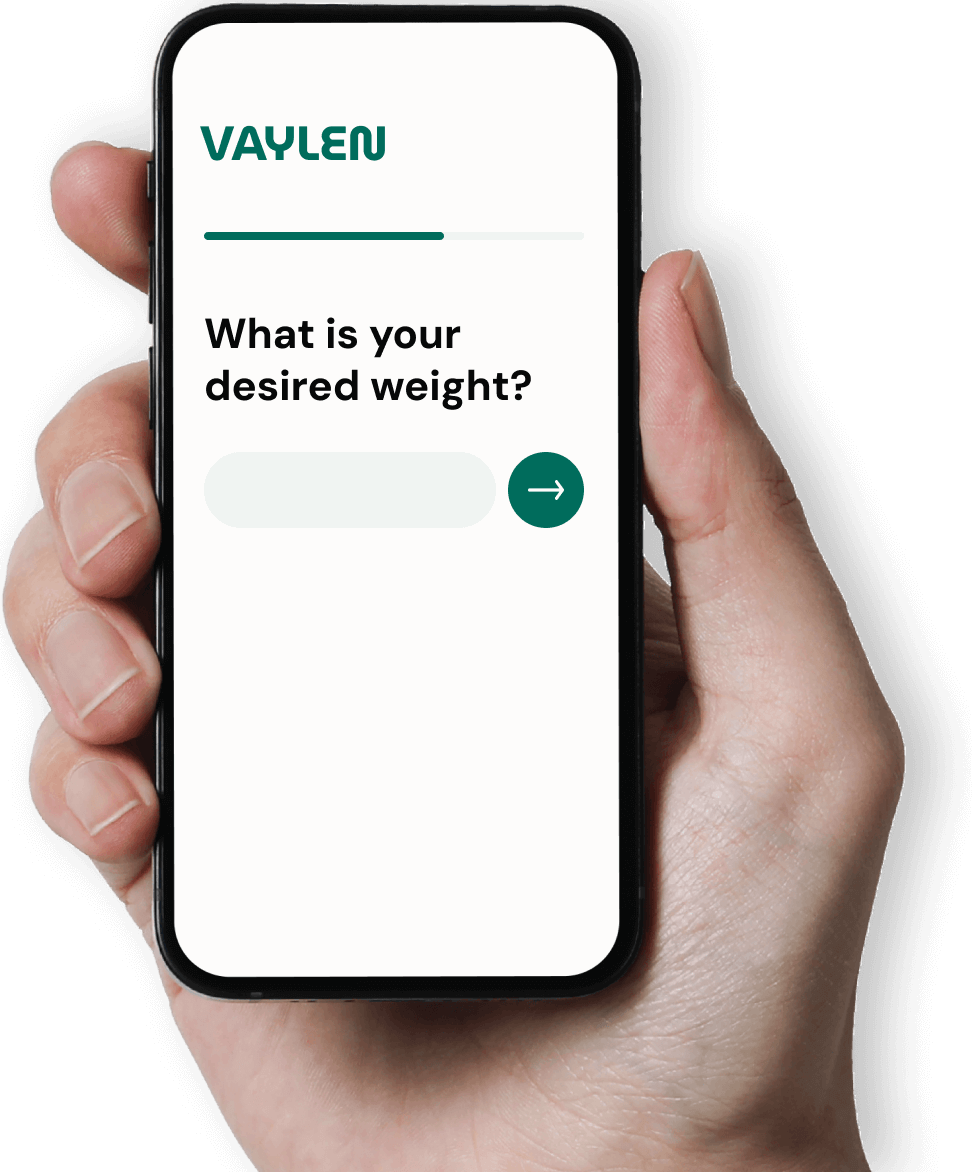Hand holding a smartphone displaying a screen with the Vaylen logo and the question 'What is your desired weight?' with an input field and a right arrow button.