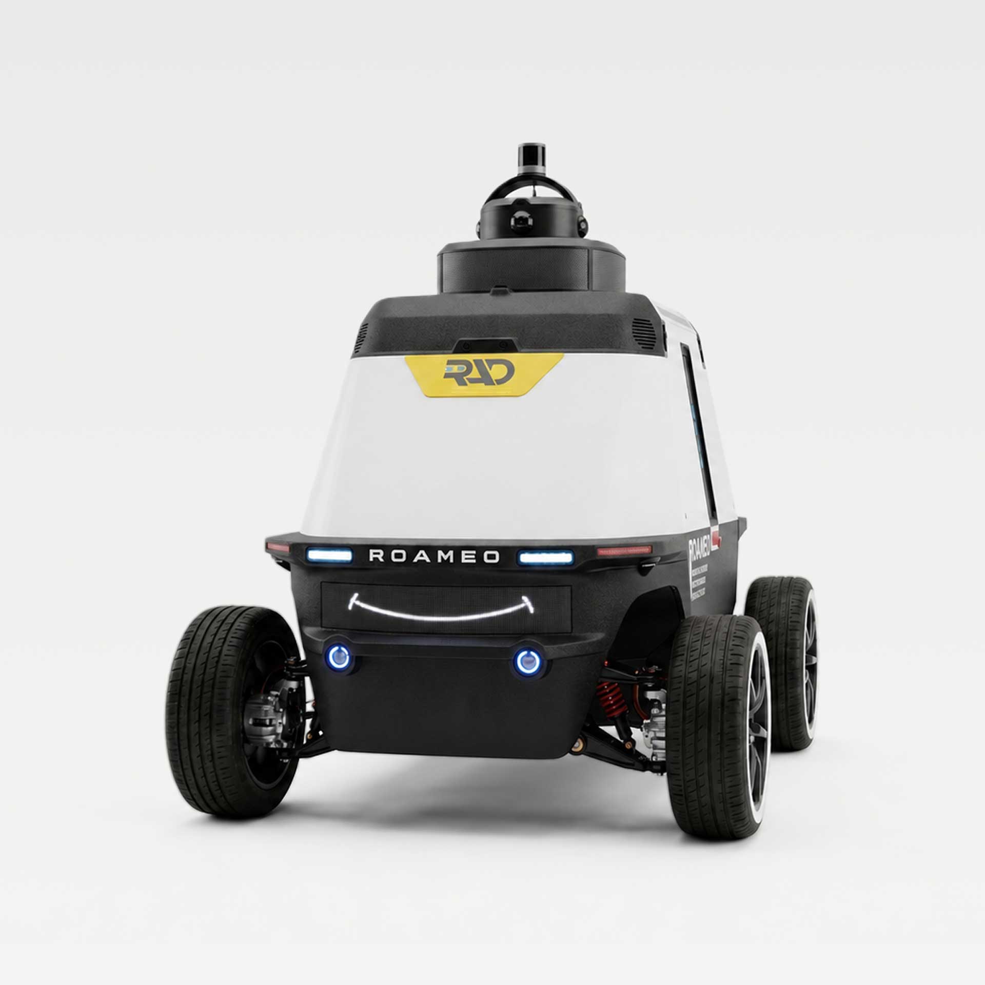 ROAMEO security patrol robot seen from the front, with its sensor mast, RAD badge, and front light bar, on a light grey background