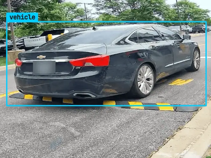 Sedan crossing a speed bump at a plate read point, plate blurred