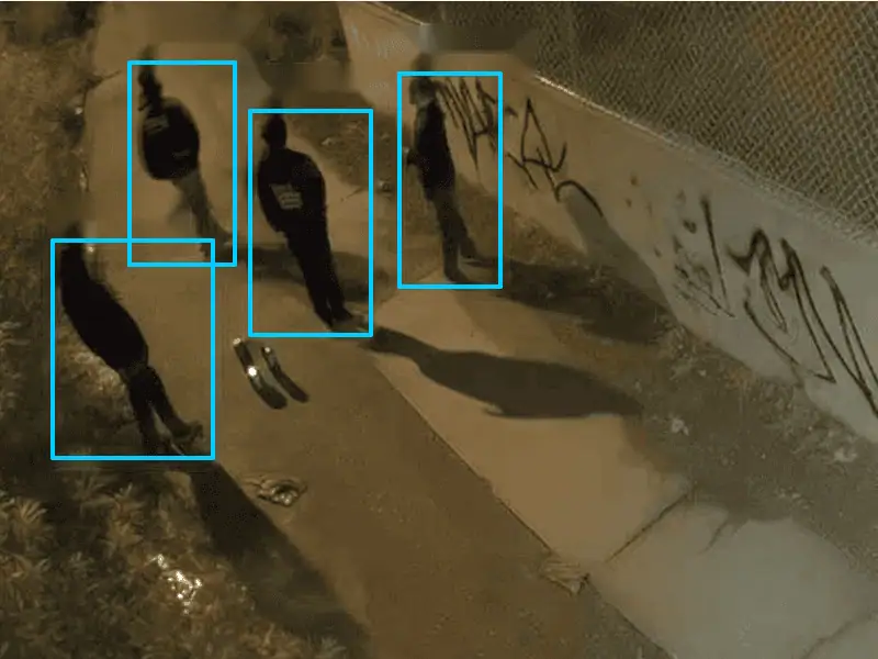 Four people detected along a fence line at night
