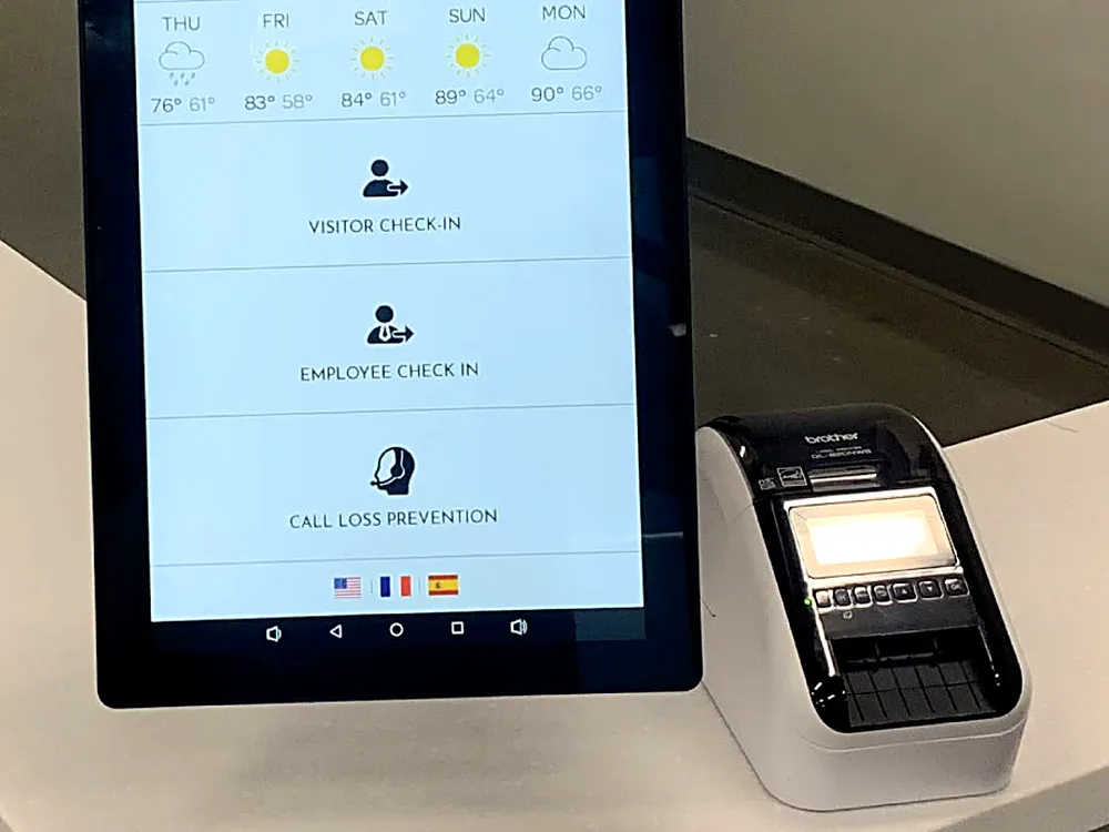 TOM touchscreen running RADGuard beside the desk label printer