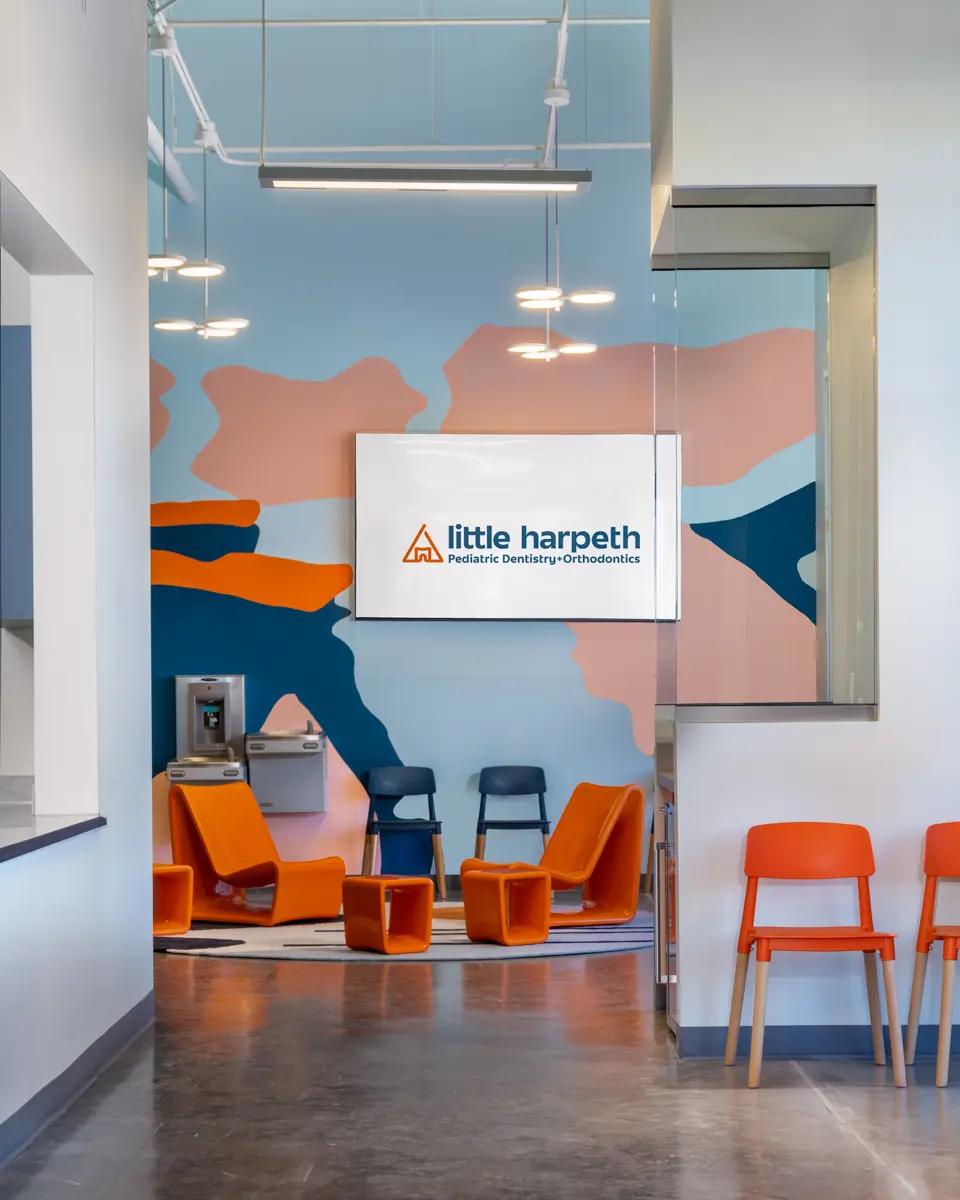 Happy Harpeth waiting room with orange chairs and a projector screen