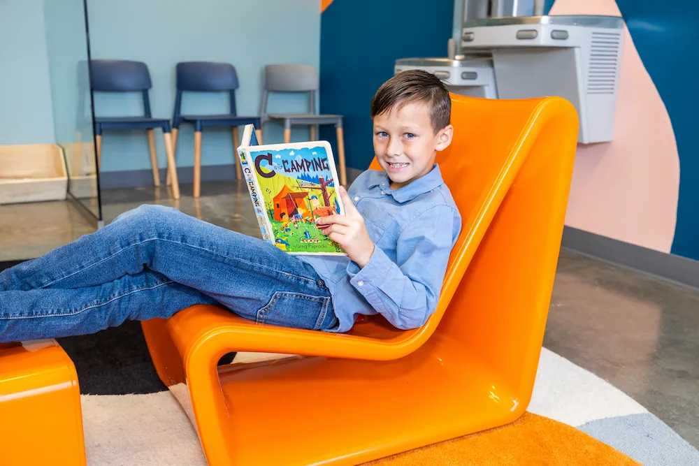 Kid reading  in the Happy Harpeth office
