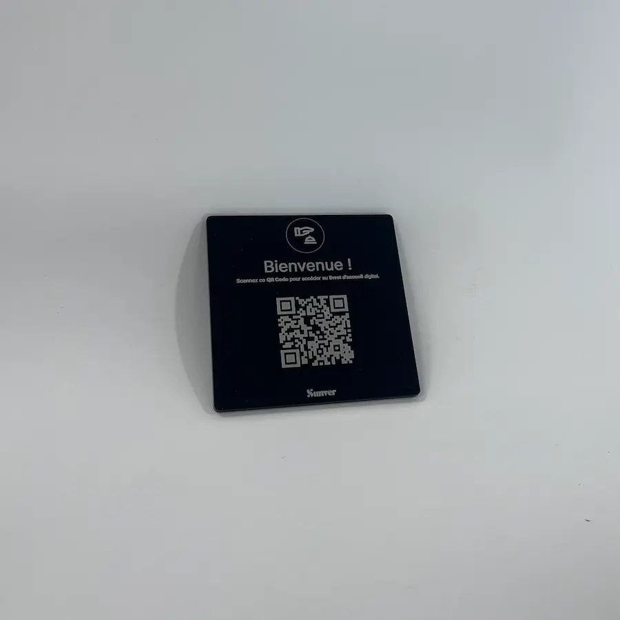 Photo of a mini plexiglass QR code plate in a compact format.