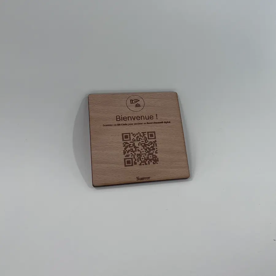 Photo of a mini wooden QR code plate on a tray.