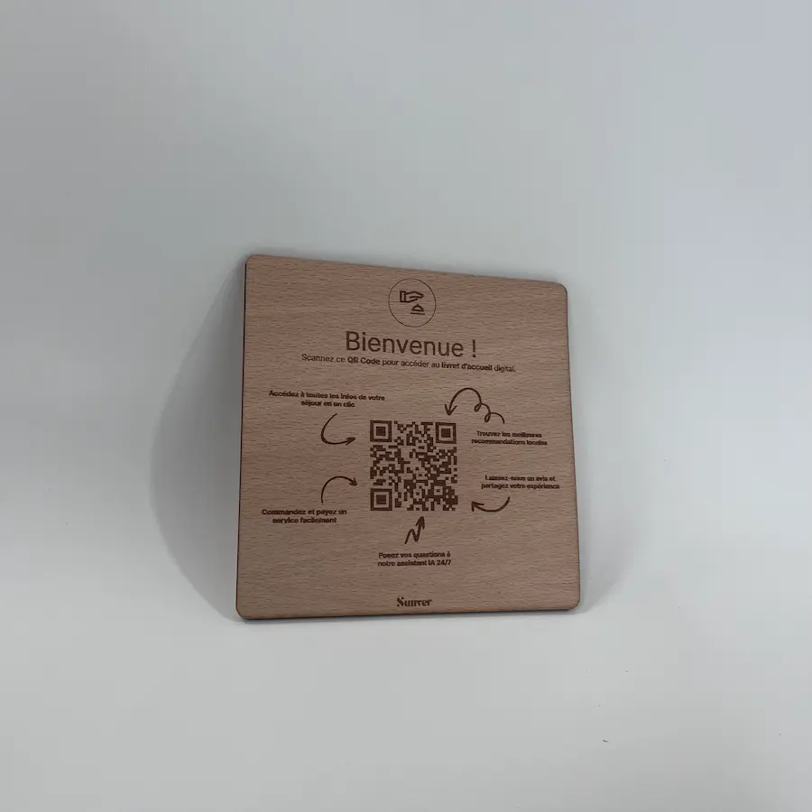 Photo of a small wooden QR code plate on a bedside table.